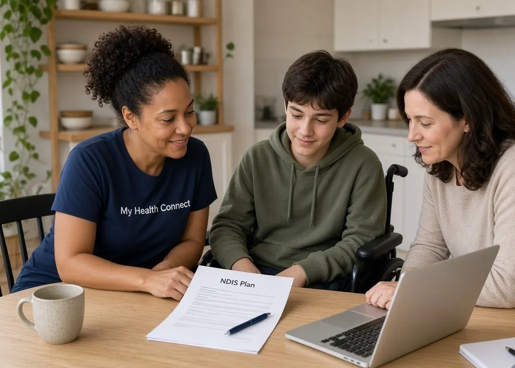 A My Health Connect support coordinator going through an NDIS plan at the kitchen table with a young participant and his mother.